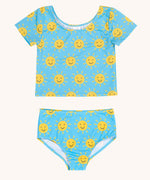Frugi blue children's tankini with an all over yellow smiley sunshine print. A short sleeved swimwear top with matching brief style bottoms.