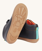 A view of the rubber soles on the Frugi cape stretch children's lace boot in black leather with salamander orange leather lining. 