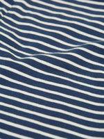 Close up of the material of the Frugi childs organic cotton navy breton stripe leona leggings.