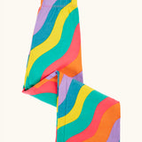 Frugi organic cotton wide leg rainbow ric rac pattern children's trousers shown folded. 