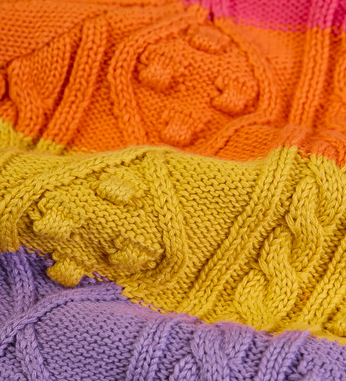 Close up of cable knit on the Frugi clay cable knit cardigan rainbow stripe organic cotton.