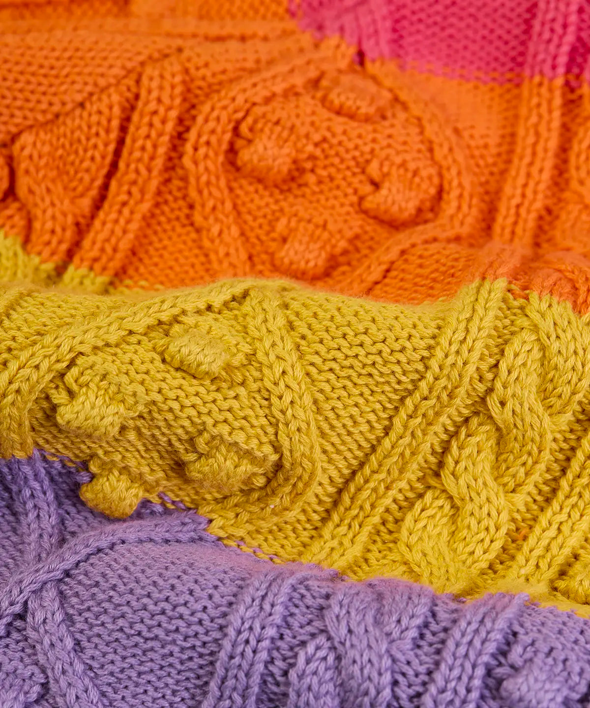 Close up of cable knit on the Frugi clay cable knit cardigan rainbow stripe organic cotton.