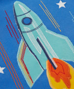 Frugi layered long sleeve top showing close up of a rocket applique on cobalt blue organic cotton fabric