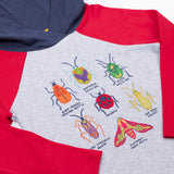 A close up of the bug design on the front of the Frugi compass hooded long sleeve bug design hoodie top.