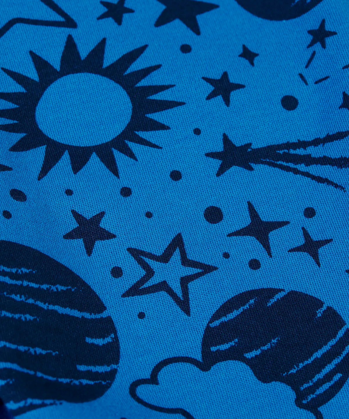 Close up of the blue monochrome space print on one side of the Frugi Gylly cord reversible children's dungaree.