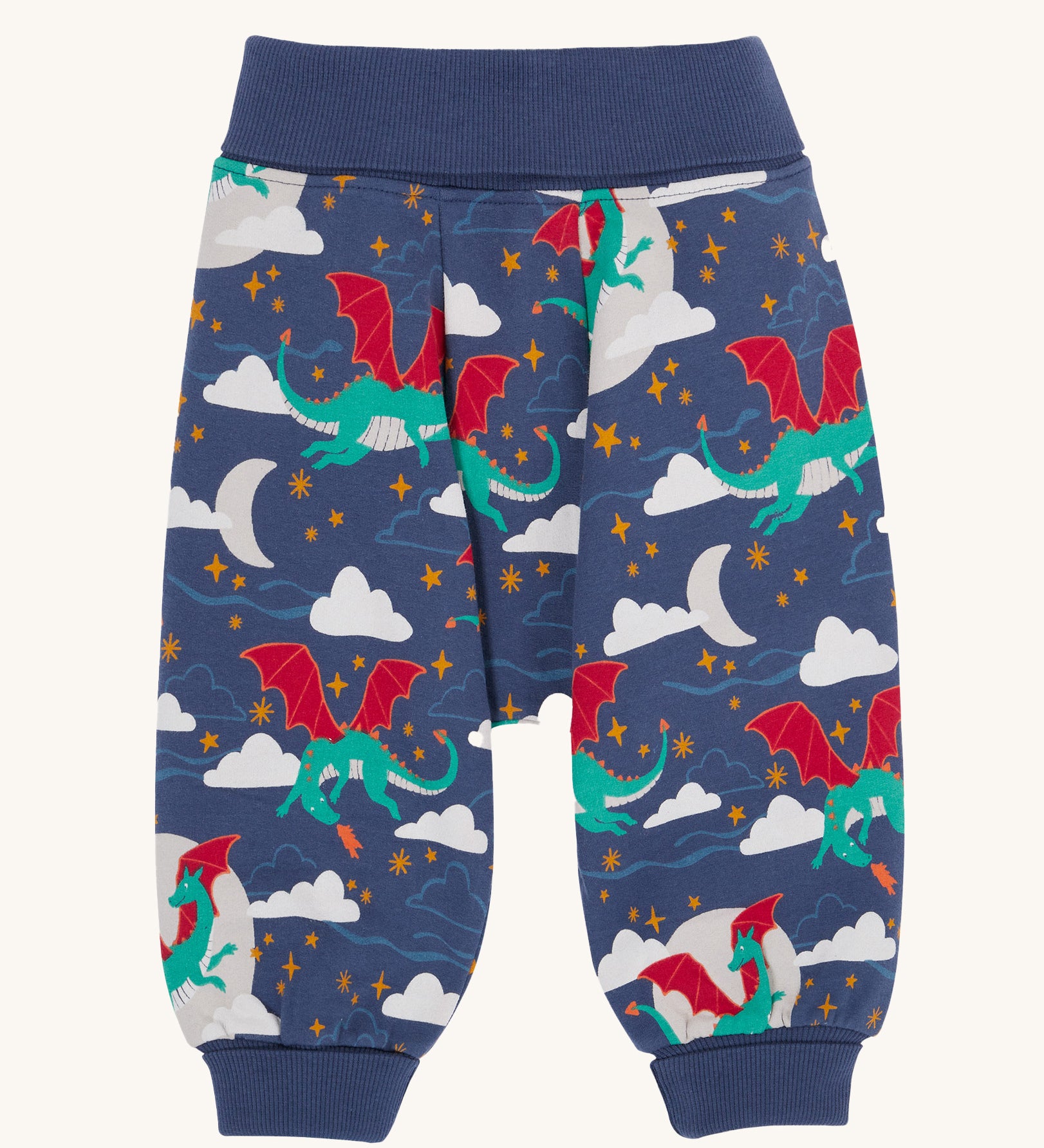Frugi Organic Cotton Cosy Parsnip Pants with a Dragon Skies print. A navy coloured trousers with a print featuring a green coloured dragon. clouds and stars. These trousers are part of a wide range of organic cotton clothing for children available here at Babipur. 