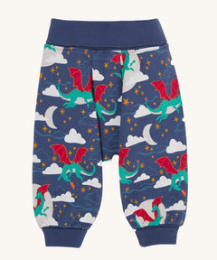 Frugi Organic Cotton Cosy Parsnip Pants with a Dragon Skies print. A navy coloured trousers with a print featuring a green coloured dragon. clouds and stars. These trousers are part of a wide range of organic cotton clothing for children available here at Babipur. 