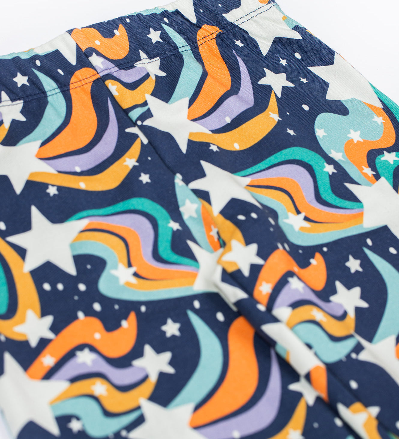 A close up of the Frugi Magic Skies Organic Cotton Cosy Flared Leggings. These warm cotton leggings are lined with a Brushback Fleece surface inside. These leggings are part of a wide range of organic cotton clothing for children available here at Babipur. 
