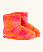A pair of frugi plush, fuzzy ankle slippers in a bright orange and pink checkerboard pattern.