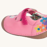 A close up of the velcro fastening on the side of the Frugi cove first walker t-bar style shoes with a bee and tulip design.