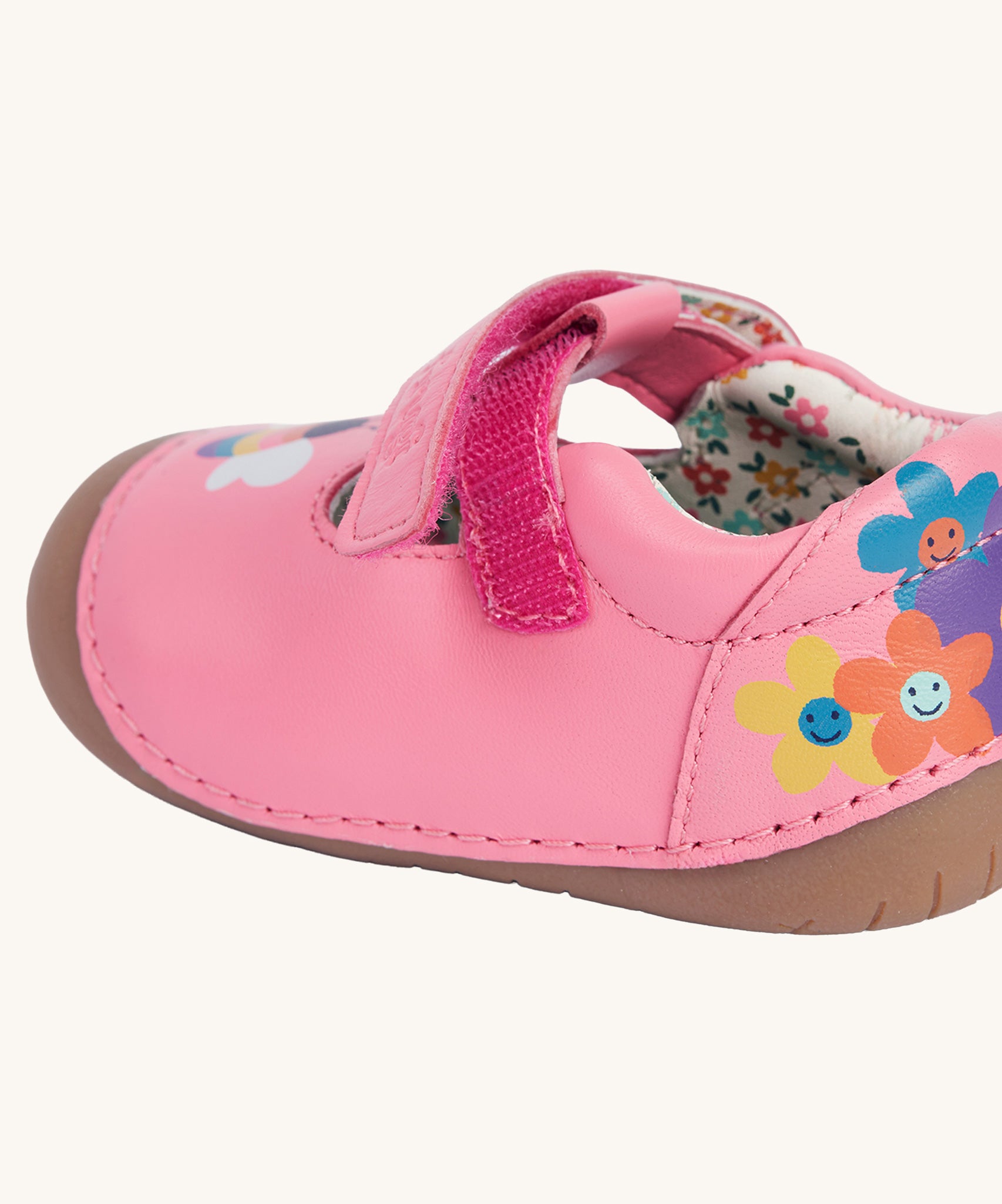 A close up of the velcro fastening on the side of the Frugi cove first walker t-bar style shoes with a bee and tulip design.