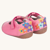 An images of the back of the Frugi cove first walker t-bar style shoes with a bee and tulip design. The back of the shoes have a colourful flower design with happy faces on them.