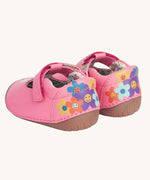 An images of the back of the Frugi cove first walker t-bar style shoes with a bee and tulip design. The back of the shoes have a colourful flower design with happy faces on them.