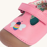 A close up of the bee details on the front of the Frugi cove first walker t-bar style shoes with a bee and tulip design. The bee has a multi-coloured body.