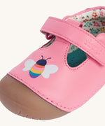 A close up of the bee details on the front of the Frugi cove first walker t-bar style shoes with a bee and tulip design. The bee has a multi-coloured body.