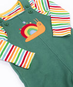 A close up of the Frugi kids coverack dungaree outfit in holly green/snail showing the playful snail applique and button fastener detail with the striped top underneath