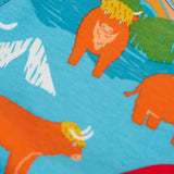 Frugi kids dungaree outfit showing a close up of the repeating highland cow print on the light blue organic cotton top 