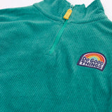 Close up of the half zip on the front of the Frugi Croft organic cord half zip jumper in hut green.
