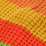 Close up of the organic cotton knit on the Frugi cuddly highland wide stripe rainbow cardigan.