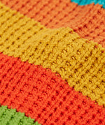 Close up of the organic cotton knit on the Frugi cuddly highland wide stripe rainbow cardigan.