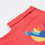 A close up of the Frugi Daisy Applique T-Shirt in Watermelon's folded sleeve.