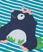 Close up of the mole applique with a worm on it's head on the front of the Frugi discovery long sleeve top in a boat blue Breton stripe.