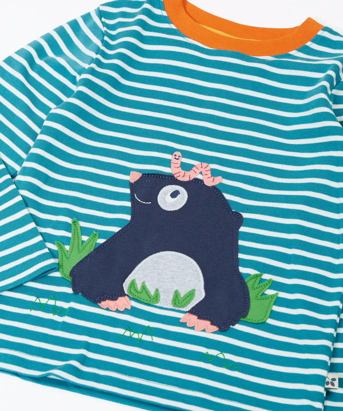 Close up of the Frugi discovery long sleeve top in a boat blue Breton stripe with a mole applique on the front with a worm on it's head.
