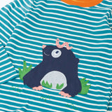 Close up of the Frugi discovery long sleeve top in a boat blue Breton stripe with a mole applique on the front with a worm on it's head.