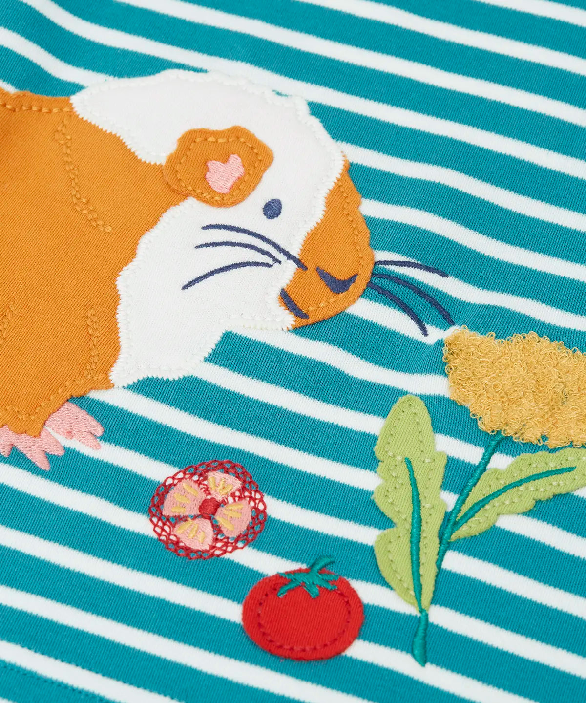 Close up of the guinea pig applique and details on the front of the Frugi discovery circular cotton long sleeve top in boat blue Breton stripe.