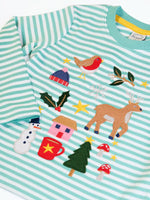 Close up of the front of the Frugi discovery organic cotton long sleeved top in miss green stripe with winter appliques. Robin, mistletoe, bobble hat, reindeer, holly, house, hot chocolate, snowman, tree, mushroom and stars. 