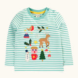 Frugi discovery organic cotton long sleeved top in miss green stripe with winter appliques. Robin, mistletoe, bobble hat, reindeer, holly, house, hot chocolate, snowman, tree, mushroom and stars. 