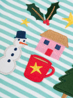 Close up of the snowman, holly tree house and hot chocolate appliques and embroidery details on the Frugi discovery organic cotton long sleeved top in miss green stripe with winter appliques.