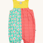 Frugi Summer Printed Dungaree in the Rainbow Hotchpotch print laid flat, showing a patchwork type design in yellow, red and green with daisies, featuring popper fastenings.