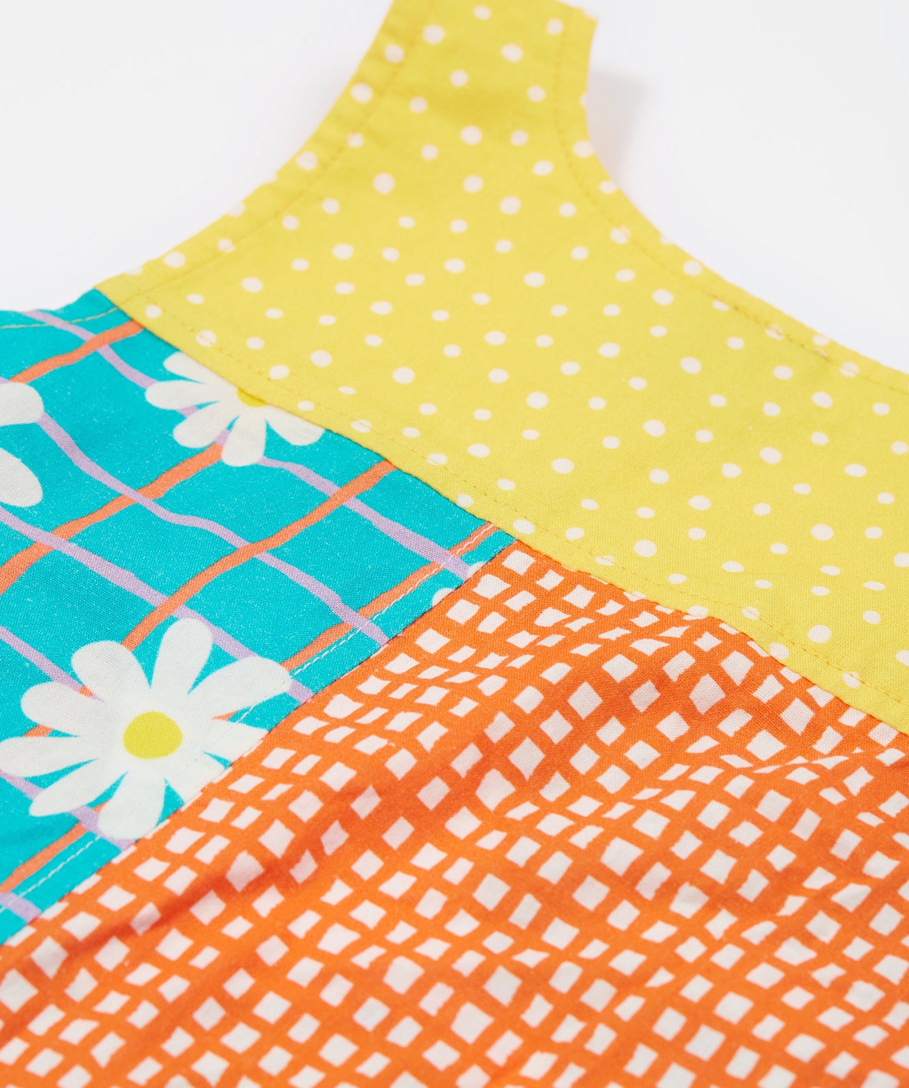 A close up of the back of the Frugi Summer Printed Dungaree in the Rainbow Hotchpotch print.