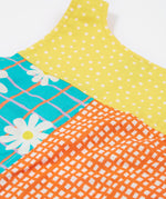 A close up of the back of the Frugi Summer Printed Dungaree in the Rainbow Hotchpotch print.