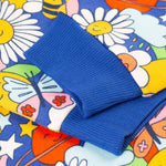 A close up of the cuffs on the sleeves of the Frugi Easy On kids Jumper with a Retro Happy print. 