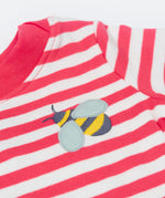 A close up of the t-shirt from the Frugi kids bee stripe outfit. Showing the bee applique with light grey wings on a light pink and white striped organic cotton fabric
