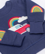Frugi easy on organic cotton navy jumper with a red vehicle on the front and rainbow patch appliques on the elbows.