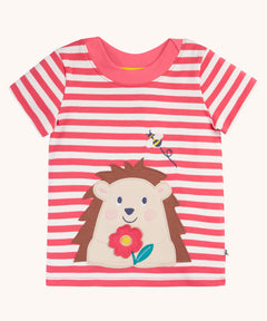 Frugi Easy On pink breton stripe hedgehog applique short sleeved organic cotton T-Shirt. The hedgehog is holding a pink flower and there is a little bee flying above.
