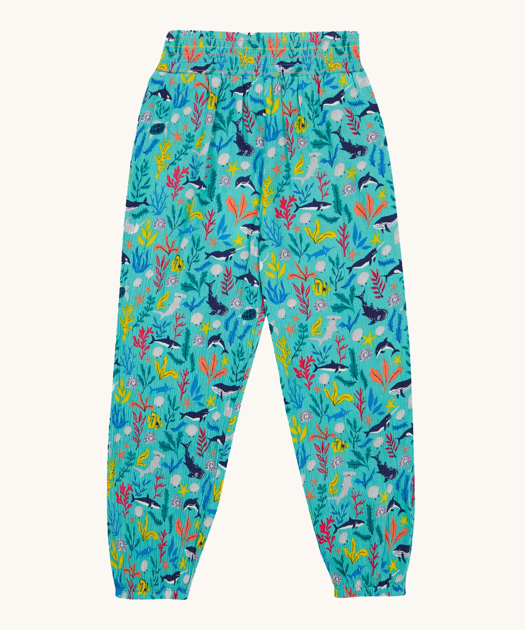 Frugi Eira Harems laid flat, featuring a Sea Life print which includes different sea animals and colourful seaweed and coral on a mint blue background.