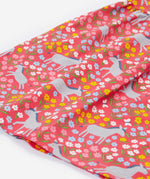 Close up of the Frugi kids Ellen dress donkey drove. Showing the gentle frill. Features grey donkeys surrounded by yellow white pink and light blue flowers on a light pink organic cotton fabric 