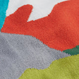 A super close view of the Frugi Elwood organic cotton knitted jumper with a blue mountain scene design showing the material.
