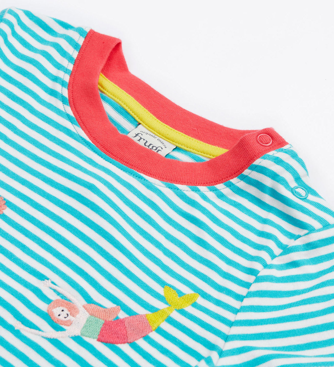 A close up of Frugi Ennis Embroidered T-Shirt in Moss Stripe, featuring swimming Mermaids and a pink collar, with popper fastenings.