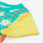 A close up of Frugi Estella Shirt's sleeve, with a Rainbow Hotchpotch print.