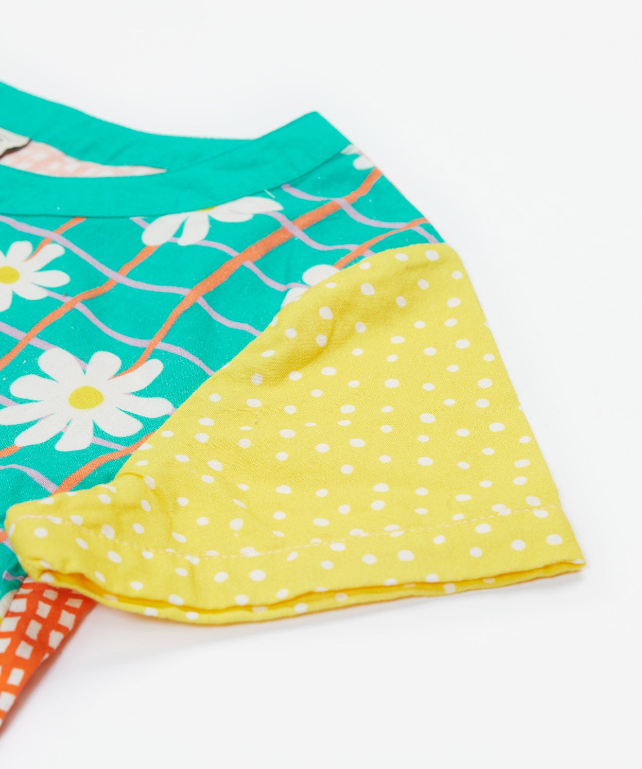 A close up of Frugi Estella Shirt's sleeve, with a Rainbow Hotchpotch print.