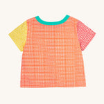 The back of the Frugi Estella Shirt laid flat, with a Rainbow Hotchpotch print, a patchwork type design in red, orange and yellow, with a mint collar.