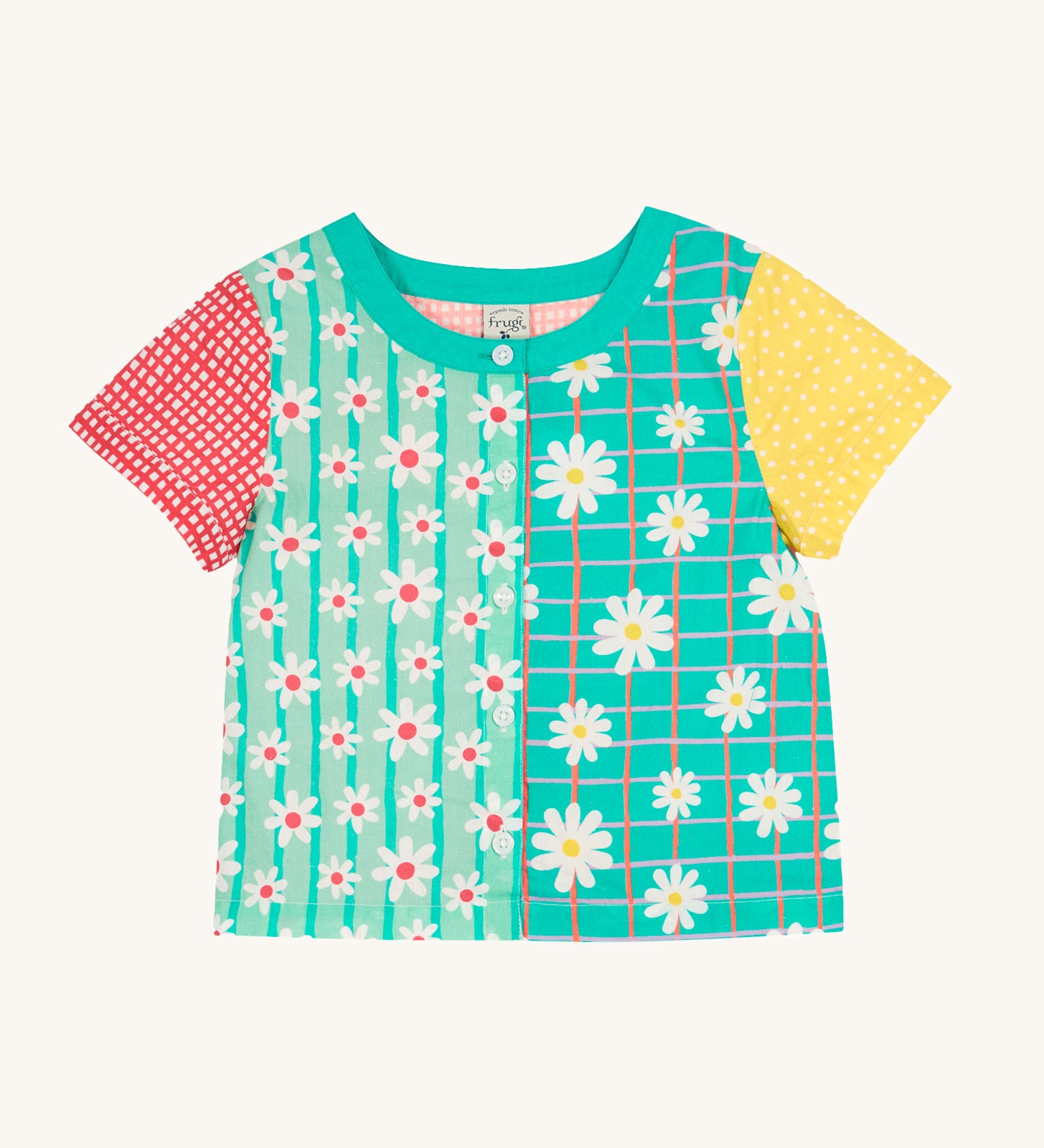 Frugi Estella Shirt laid flat, with a Rainbow Hotchpotch print, a patchwork type design in red, mint, green and yellow with daisies and white buttons down the middle.
