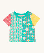Frugi Estella Shirt laid flat, with a Rainbow Hotchpotch print, a patchwork type design in red, mint, green and yellow with daisies and white buttons down the middle.