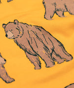 A close up of the Frugi kids Ethan printed sweater in beary wild. Showing the brown bear print detail on dark yellow organic cotton fabric.