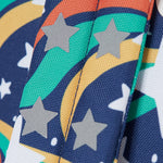 A close up of the shoulder strap on the Frugi magic stars explorer backpack showing the reflective stars detail. 